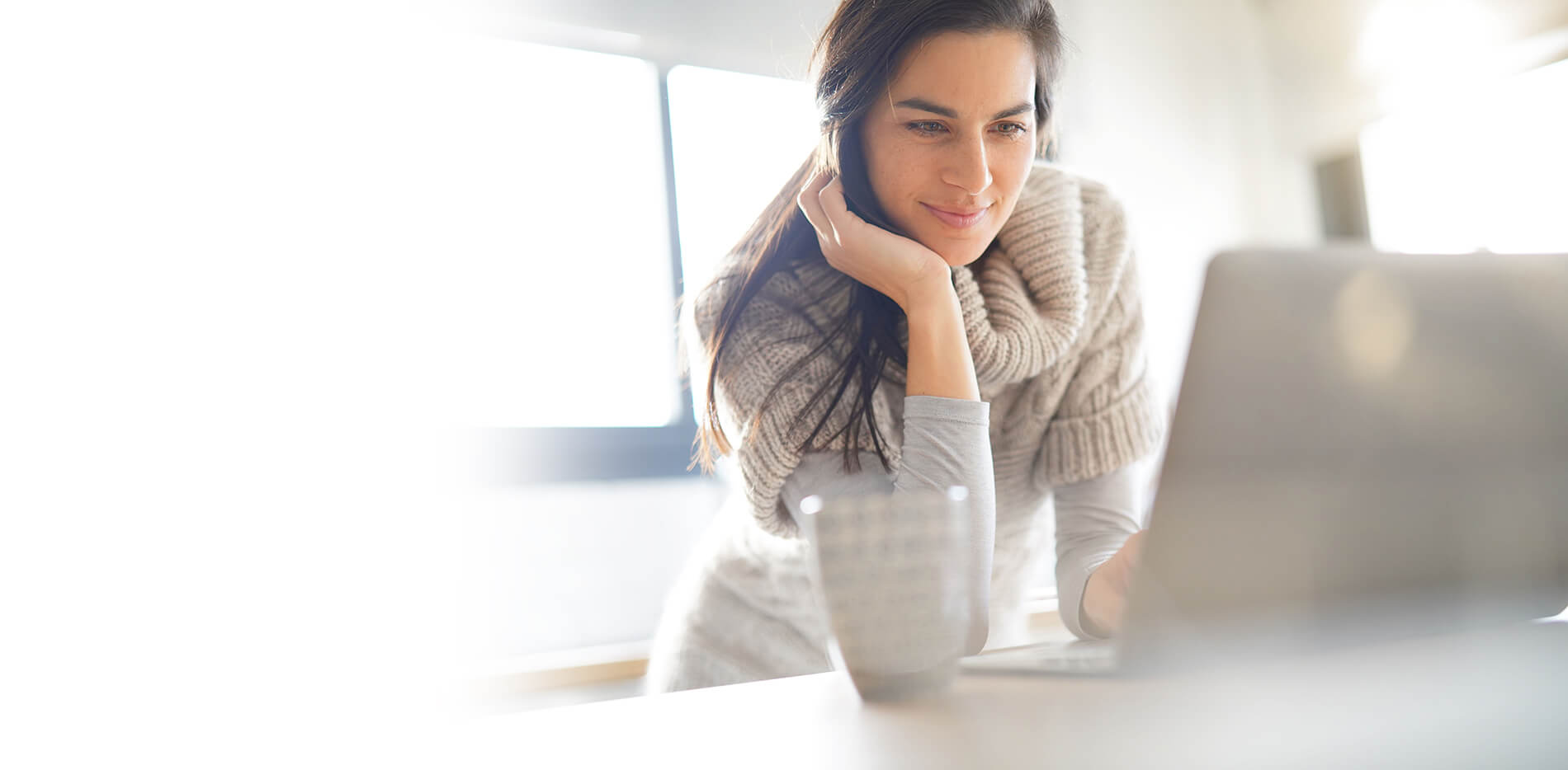 Woman standing looking at a computer